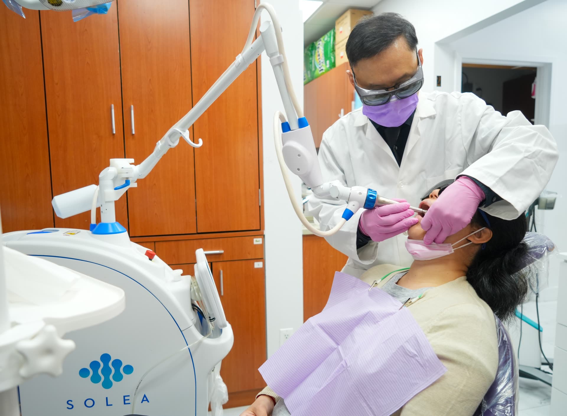 Dr. John Shi performing a precision chairside procedure at Centre Dental NYC — twenty years of clinical expertise in Lower Manhattan