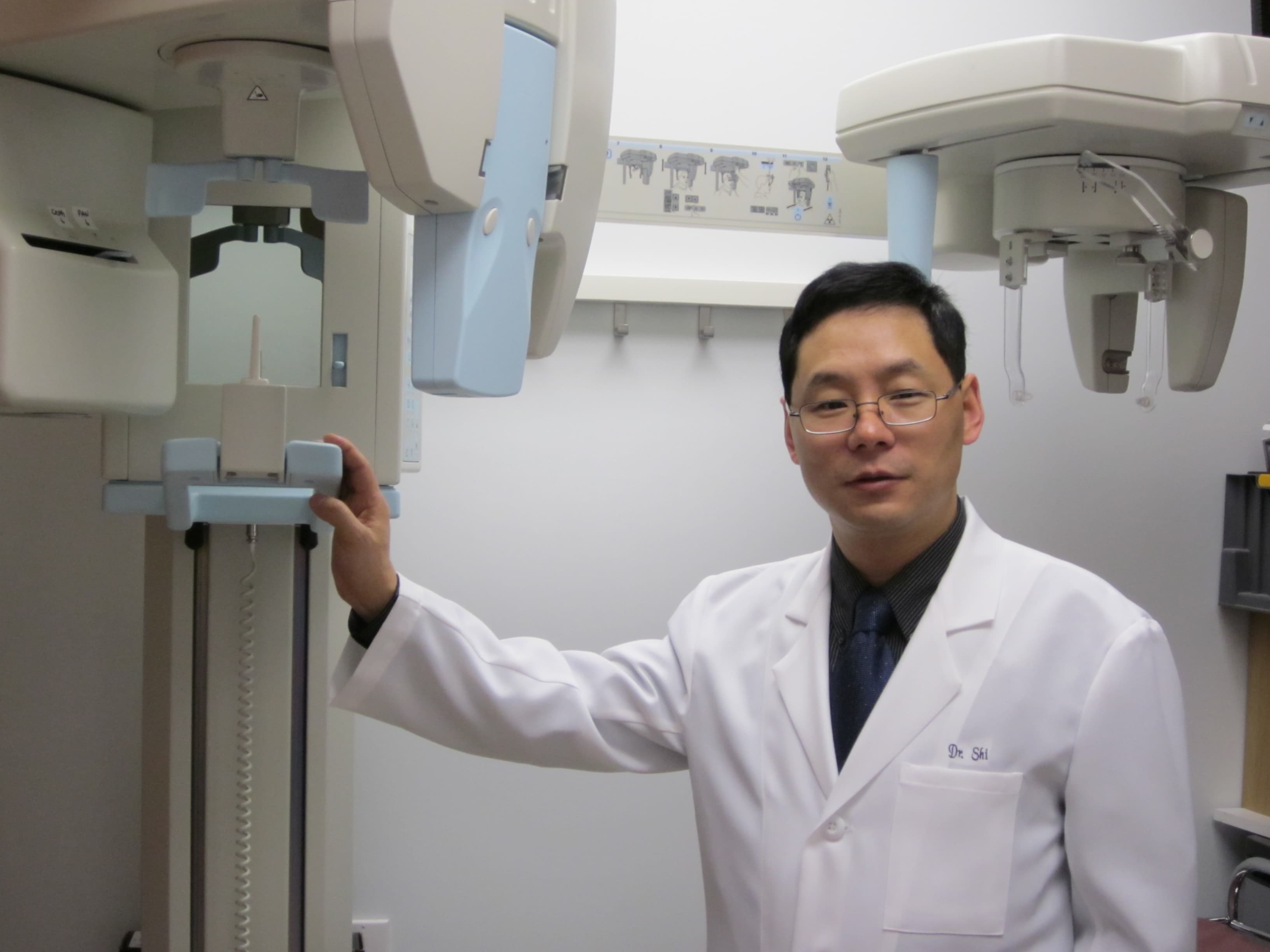 Dr. John Shi beside the CBCT scanner at Centre Dental NYC